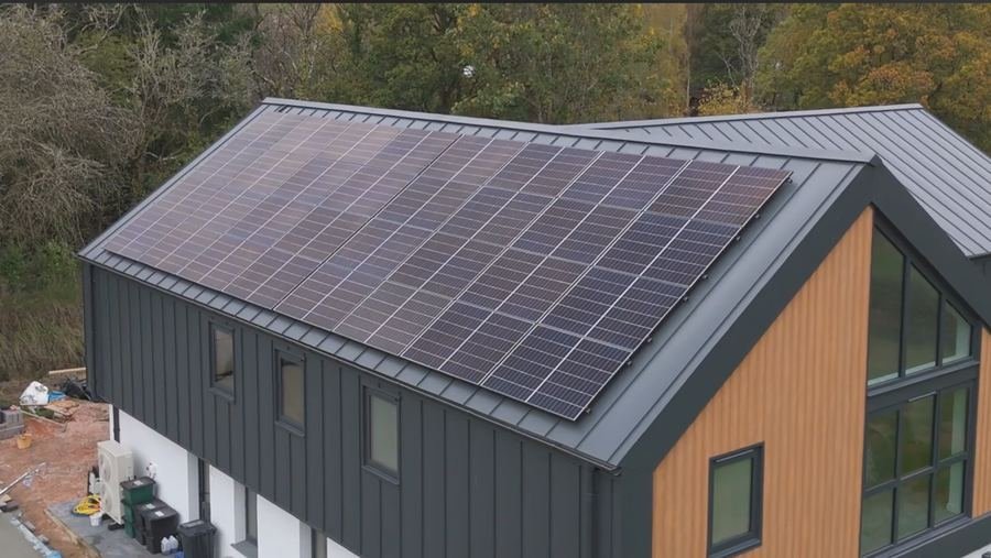Solar panels across a long pitched roof on a new-build house
